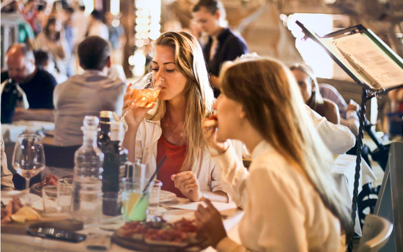 girls drinking and eating in a restaurant